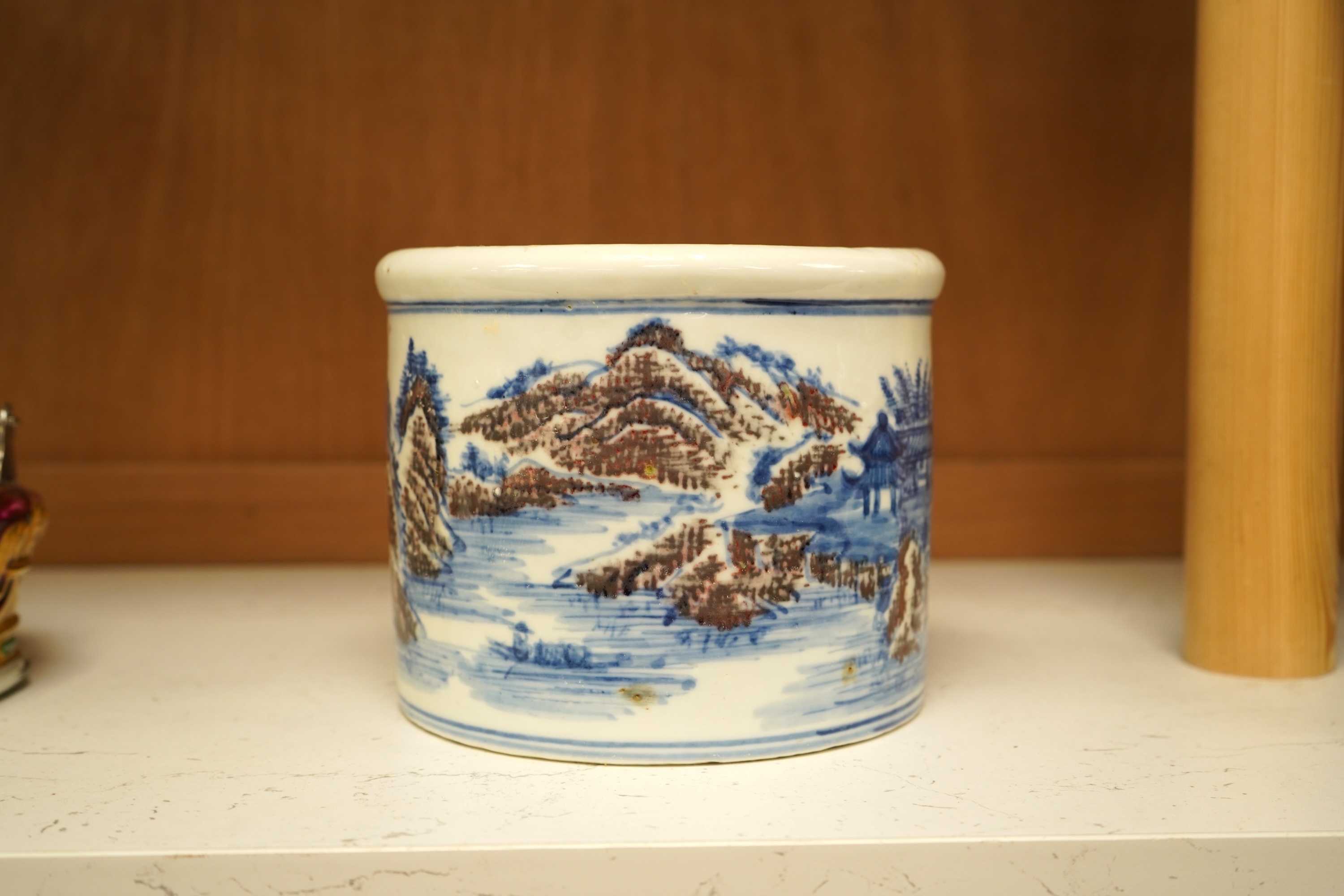 A Chinese blue and white with iron red cylindrical brush pot, 15cm in diameter